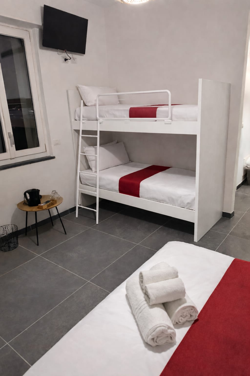 Letto matrimoniale e letto a castello visibili nella camera Rododendro